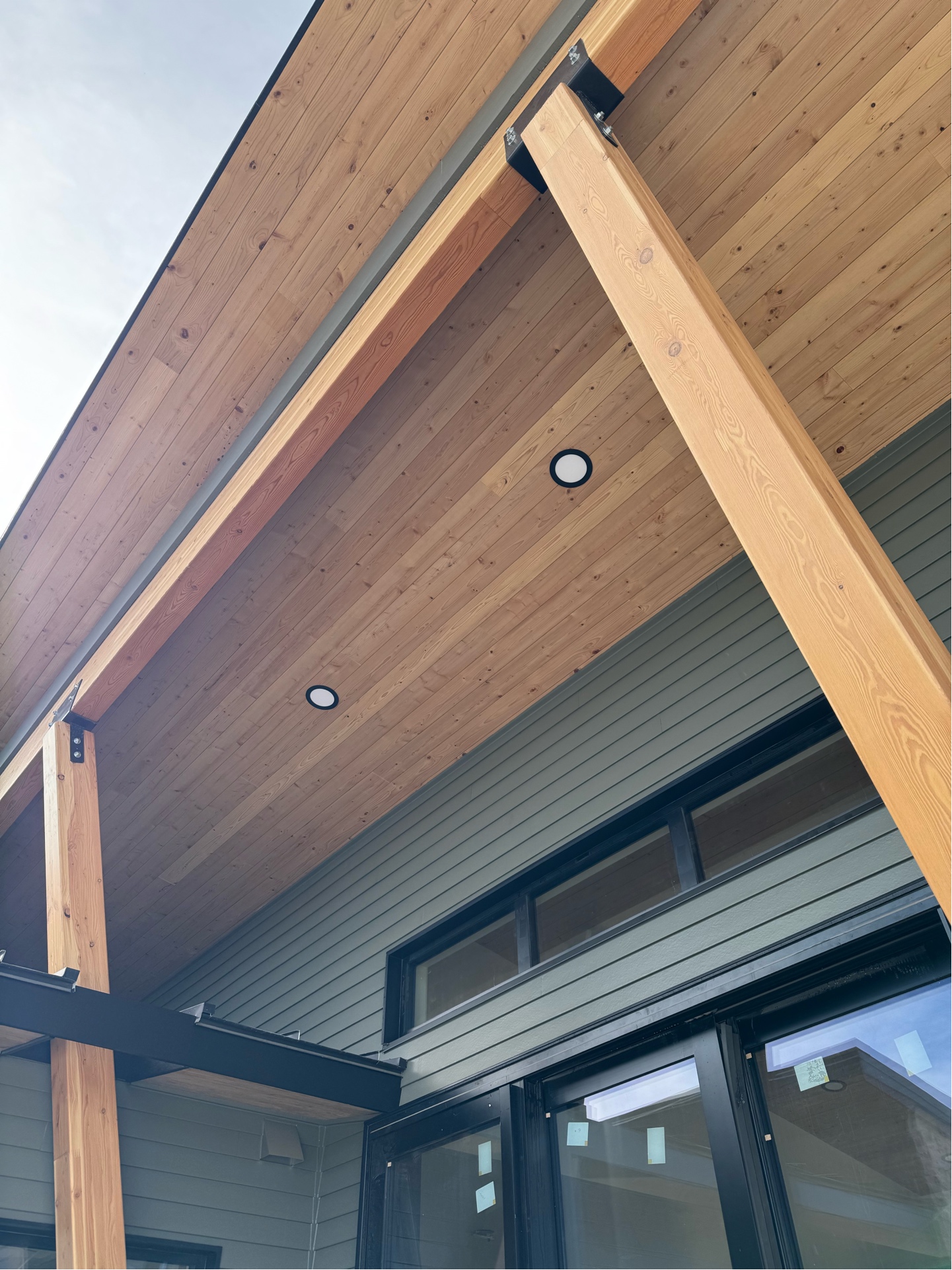 Black wafer lights in cedar soffit with timber beams