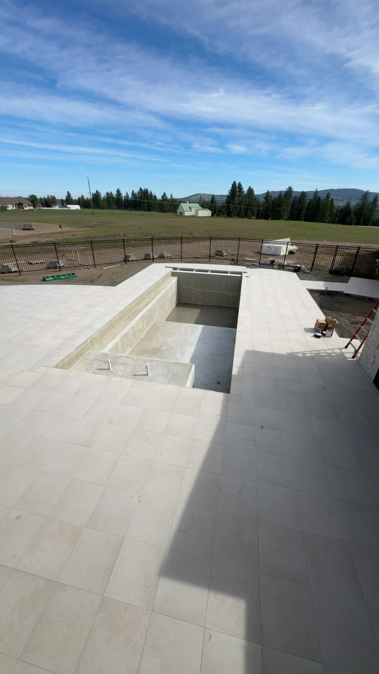 Aerial view of custom pool build with paver deck and mountain views
