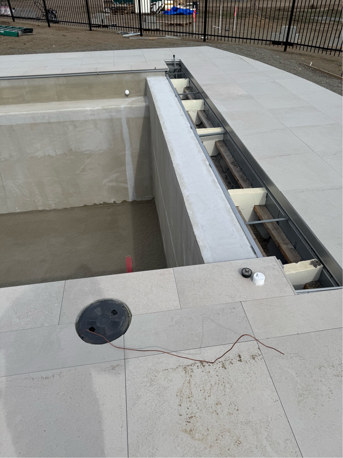 Pool bonding junction box and copper grounding tails with paver deck