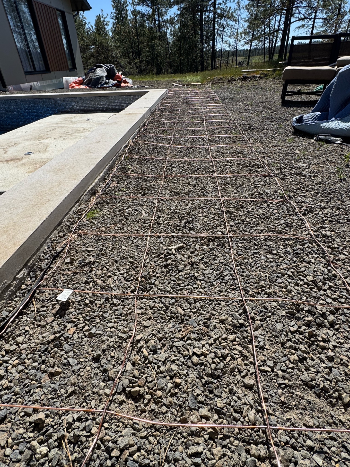 Copper bonding grid laid out around pool perimeter per NEC code